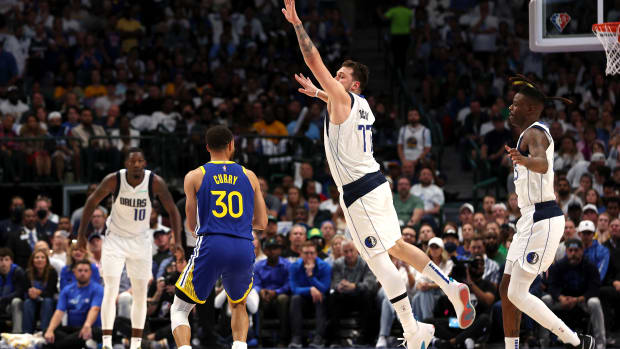 DALLAS, TEXAS - MAY 24: Luka Doncic #77 of the Dallas Mavericks jumps to stop a three point basket by Stephen Curry #30 of the Golden State Warriors during the second quarter in Game Four of the 2022 NBA Playoffs Western Conference Finals at American Airlines Center on May 24, 2022 in Dallas, Texas. NOTE TO USER: User expressly acknowledges and agrees that, by downloading and or using this photograph, User is consenting to the terms and conditions of the Getty Images License Agreement. (Photo by Tom Pennington/Getty Images)