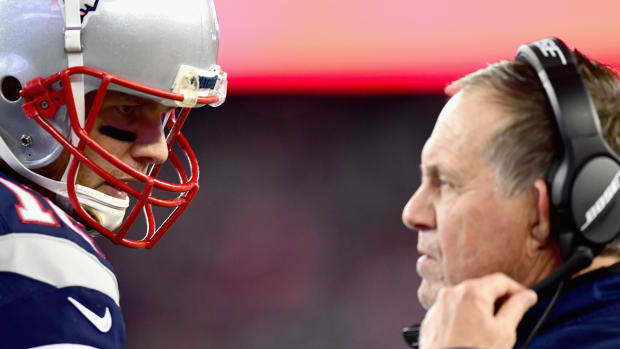 Tom Brady and Bill Belichick stand face-to-face.