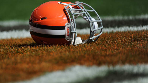 A closeup of a Cleveland Browns helmet on the field.