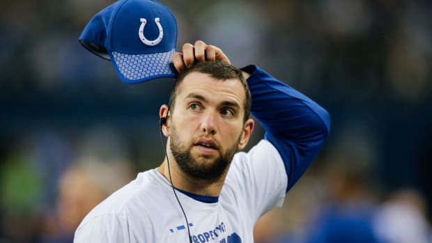 Colts QB Andrew Luck scratches his head before a game.