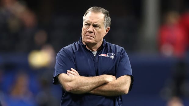 A closeup of New England Patriots coach Bill Belichick crossing his arms during a game.