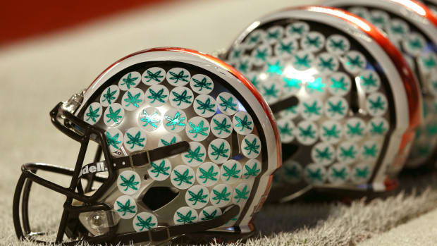 A closeup of an Ohio State football helmet with Buckeyes stickers.