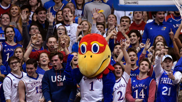 The Kansas Jayhawk mascot celebrating with fans.