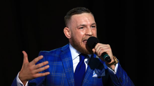 Conor McGregor speaking into a microphone.