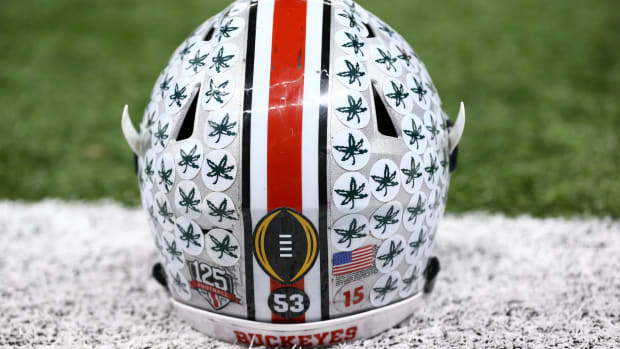A closeup of an Ohio State football helmet on the field.