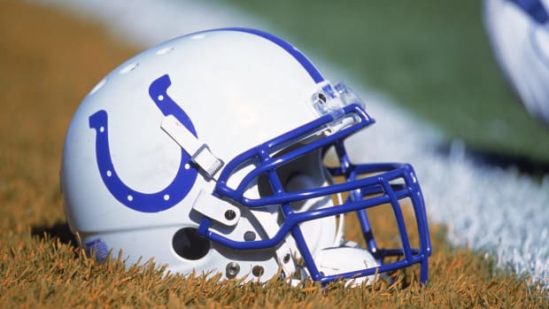 An Indianapolis Colts helmet sitting on the field.