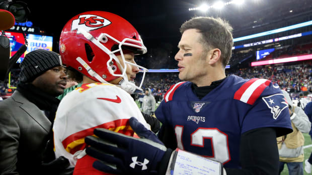 NFL legend Tom Brady shakes Patrick Mahomes' hand following a Patriots-Chiefs game.