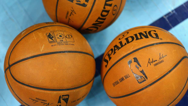 A picture of three NBA basketballs.
