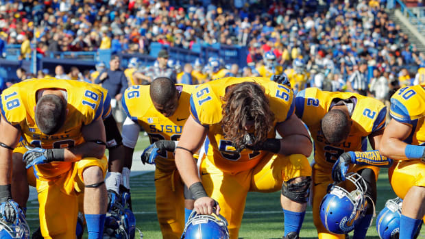 San Jose State players pray in the end zone before a game.