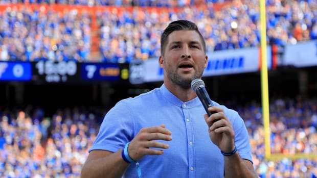 Tim Tebow giving a speech during a Florida Gators football game.