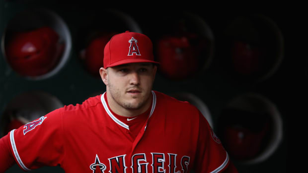 Mike Trout stands in the dugout.