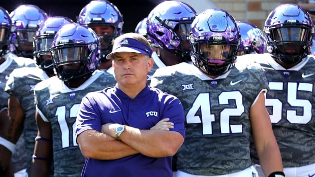 Gary Patterson standing with his arms folded.