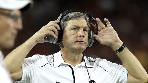 A closeup of Kirk Ferentz on the sideline during a football game.