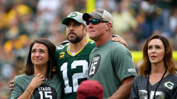 Brett Favre stands with Aaron Rodgers before a Packers game.