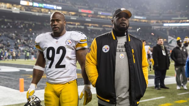 James Harrison and Mike Tomlin walk off the field.