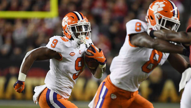 Travis Etienne carries the ball for Clemson football against Alabama in the national title game.