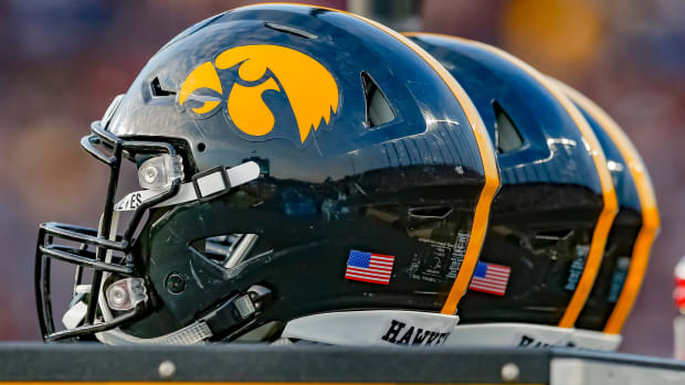 A group of Iowa Hawkeyes football helmets.