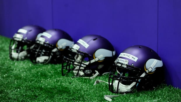 Four Minnesota Vikings helmets sitting on the field.