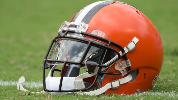 A Cleveland Browns helmet sitting on the field.
