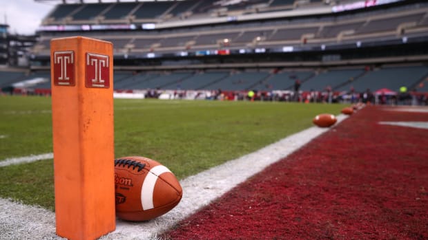 A football resting by the pylon at the Temple Owls game
