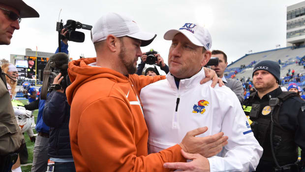 Tom Herman and David Beaty embrace after Texas-Kansas game.