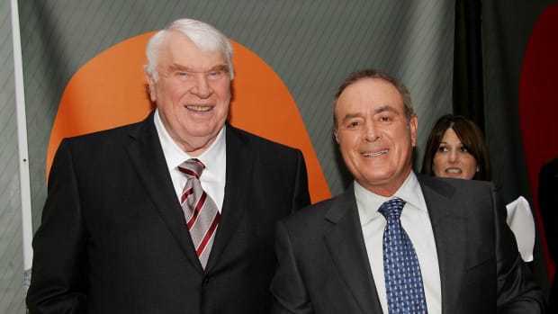 John Madden and Al Michaels posing for a photo.