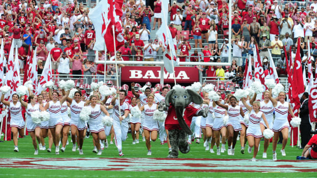 Members of the Alabama Crimson Tide take the field before the game against the Florida Atlantic Owls at Bryant-Denny Stadium.
