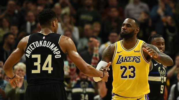 NBA stars LeBron James of the Los Angeles Lakers and Giannis Antetokounmpo of the Milwaukee Bucks hug after a game.