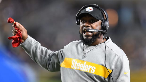 A closeup of Pittsburgh Steelers coach Mike Tomlin holding a challenge flag.