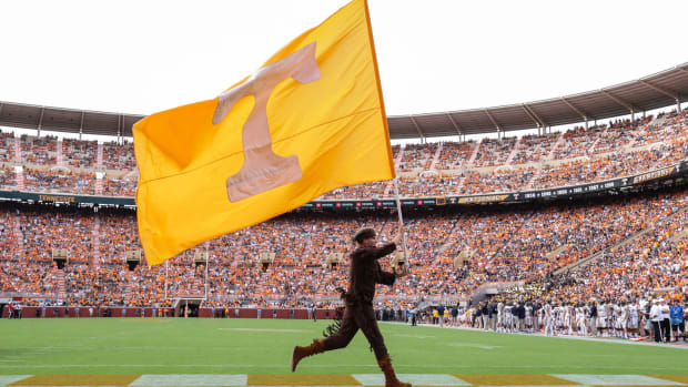 Tennessee's mascot running with a Tennessee flag.