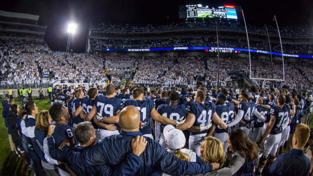 Penn State football players sing to celebrate win.