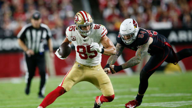 George Kittle runs with the football for the San Francisco 49ers.