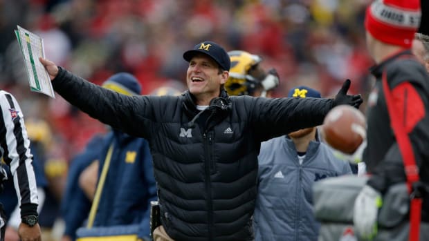 Head coach Jim Harbaugh of the Michigan Wolverines reacts to a roughing the kicker call against his team during the first quarter against the Ohio State Buckeyes.
