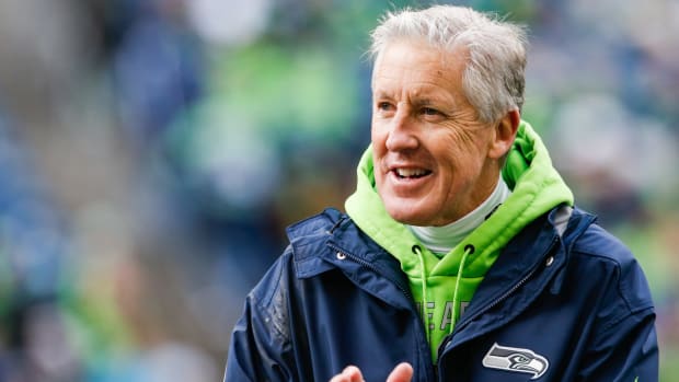 A closeup of Seattle Seahawks coach Pete Carroll clapping.