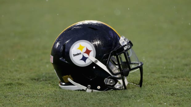 A Pittsburgh Steelers helmet sitting on the field.