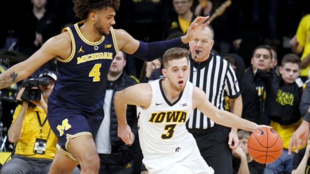 Iowa's Jordan Bohannon dribbles past Michigan's Isaiah Livers.