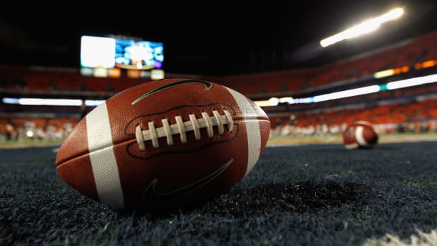 A detail of a Nike official NCAA size football as it sits in the end zone while the West Virginia Mountaineers stretchon the field prior to playing against the Clemson Tigers during the Discover Orange Bowl at Sun Life Stadium.