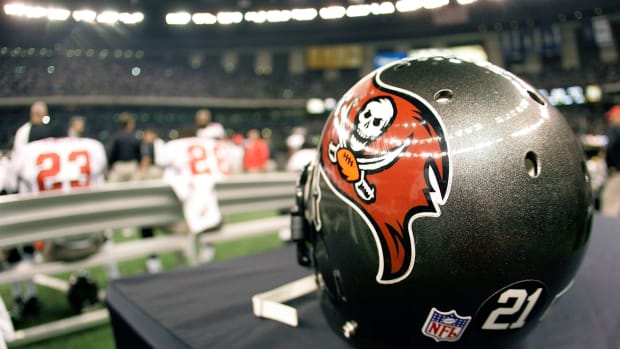 A Tampa Bay Buccaneers helmet sitting on the sideline.
