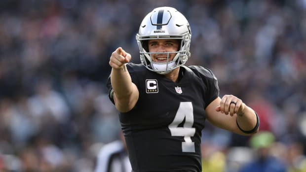 A closeup of Las Vegas Raiders QB Derek Carr pointing with one finger during a game against the Kansas City Chiefs.