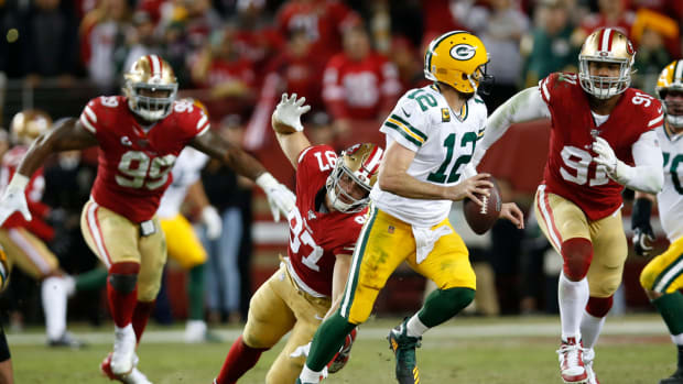 Aaron Rodgers rolls out for a pass against the 49ers.