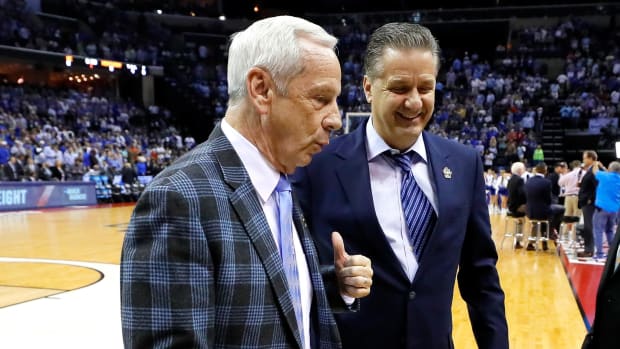 Roy Williams and John Cailpari, two college basketball greats, on the court.