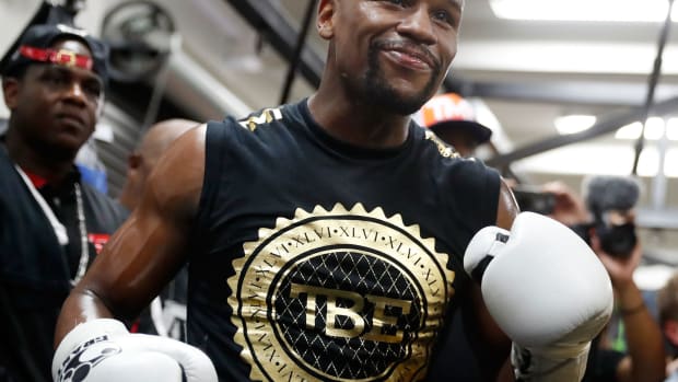 Floyd Mayweather smiles during a workout.