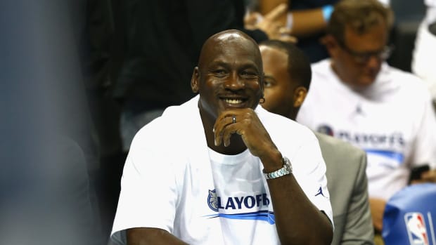 Michael Jordan smiling during an NBA game.