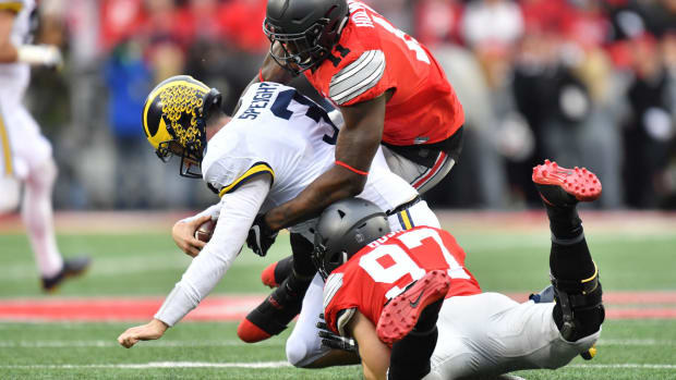 Nick Bosa and Jalyn Holmes of the Ohio State Buckeyes sack Wilton Speight #3 of the Michigan Wolverines.