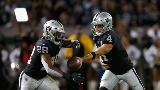 Derek Carr hands the ball off to Josh Jacobs of the Oakland Raiders.