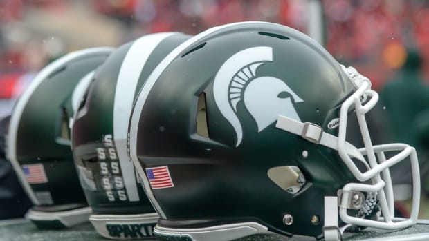 A closeup of three Michigan State football helmets before a game.