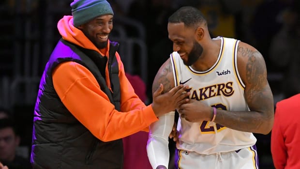 LeBron James and Kobe Bryant address each other before a Lakers game.