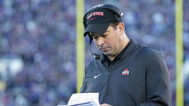 Ohio State coach Ryan Day looking over his notes during a football game.