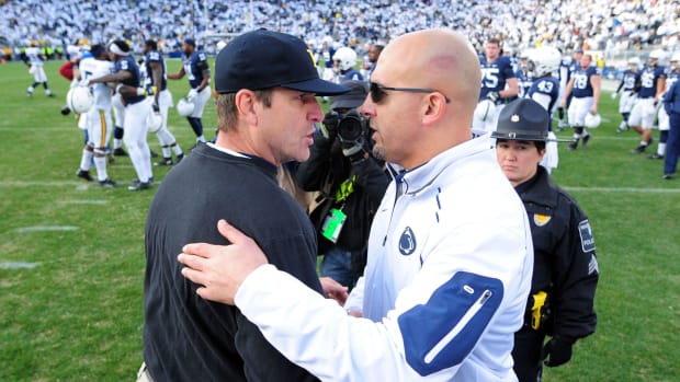Michigan coach Jim Harbaugh and Penn State coach James Franklin shaking hands after a football game.