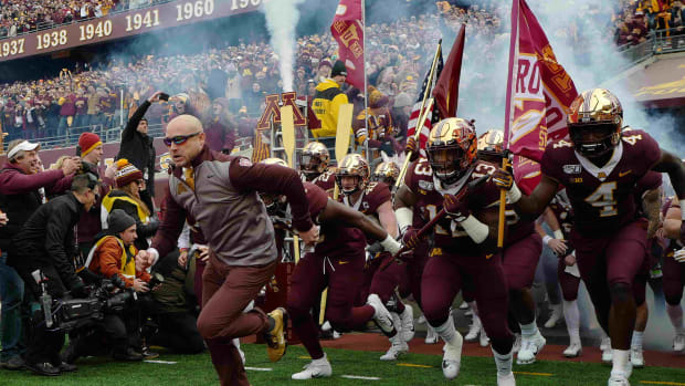 P.J. Fleck leads Minnesota onto the field ahead of a game with Penn State during the 2019 season.